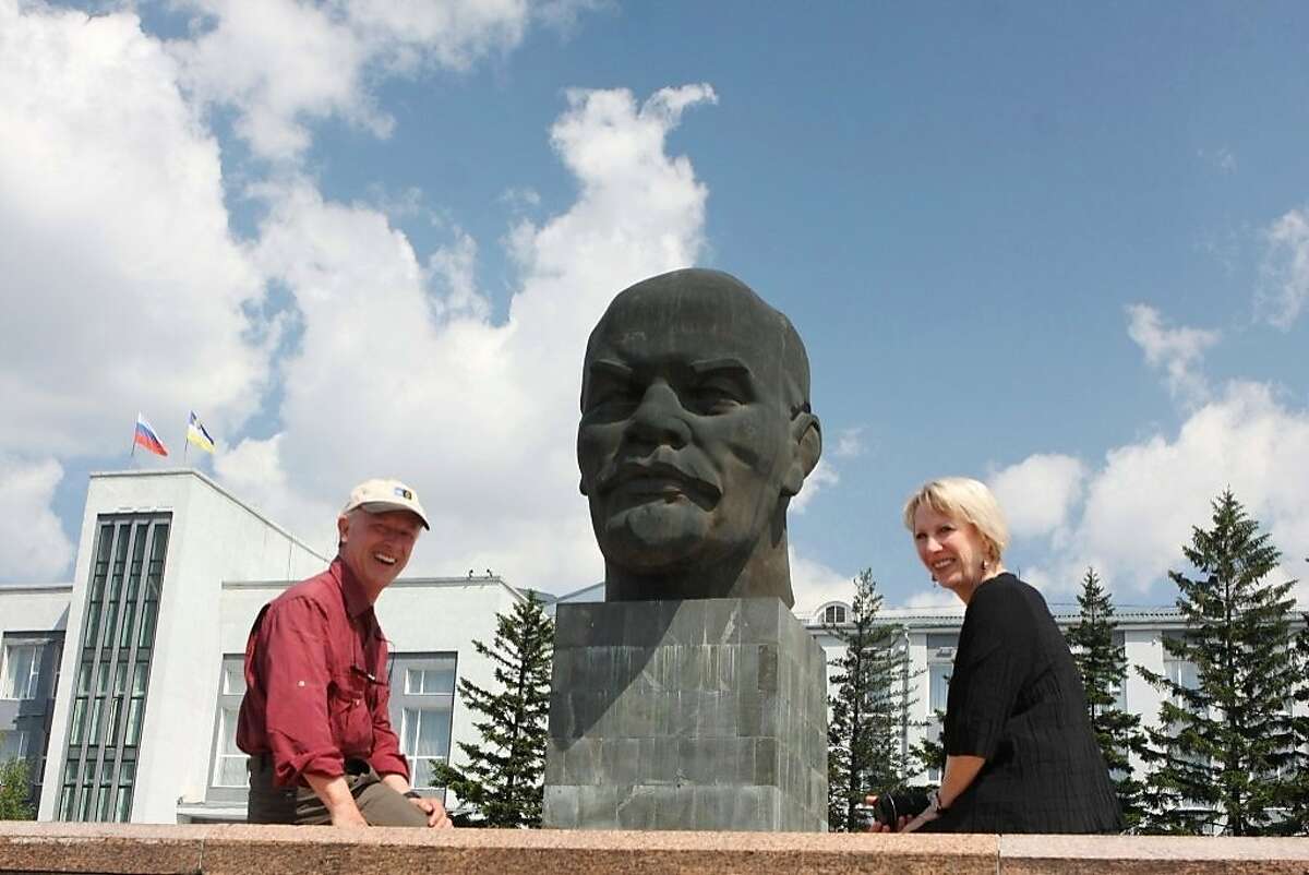 Arnette and Joe Whitehouse in Ulan Ude, Russia in front of 42 ton 25 foot tall Lenin bust.