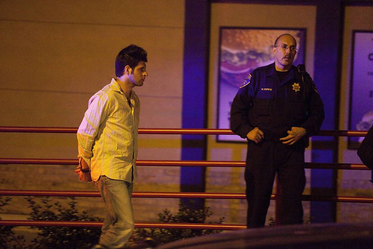 Andrew Alan Vargas, 21, is arrested near his Hayward apartment on suspicion of felony hit-and-run and driving under the influence in connection with a crash in San Francisco at Mission and New Montgomery streets about 10:40 p.m. Thursday. At right, R. Topete of the Hayward police department oversees the transfer for the suspect to SFPD.
