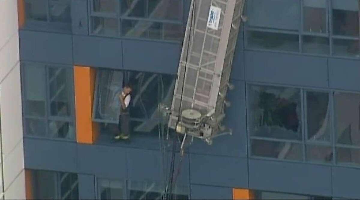 Two window washers were rescued this morning after their scaffolding broke and left them dangling outside a high-rise condominium building in San Francisco's Mission Bay.