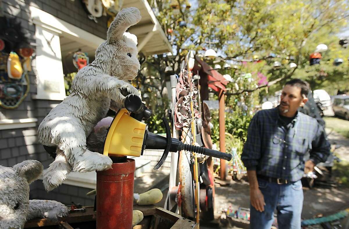 Artist Mark Olivier near his "Modern Pirates", one the many works of art he has displayed in the front yard of his Berkeley, Ca. home on Tuesday August 2, 2011. Olivier has collected items washed up on the shores of San Francisco Bay and turned the junk into art.