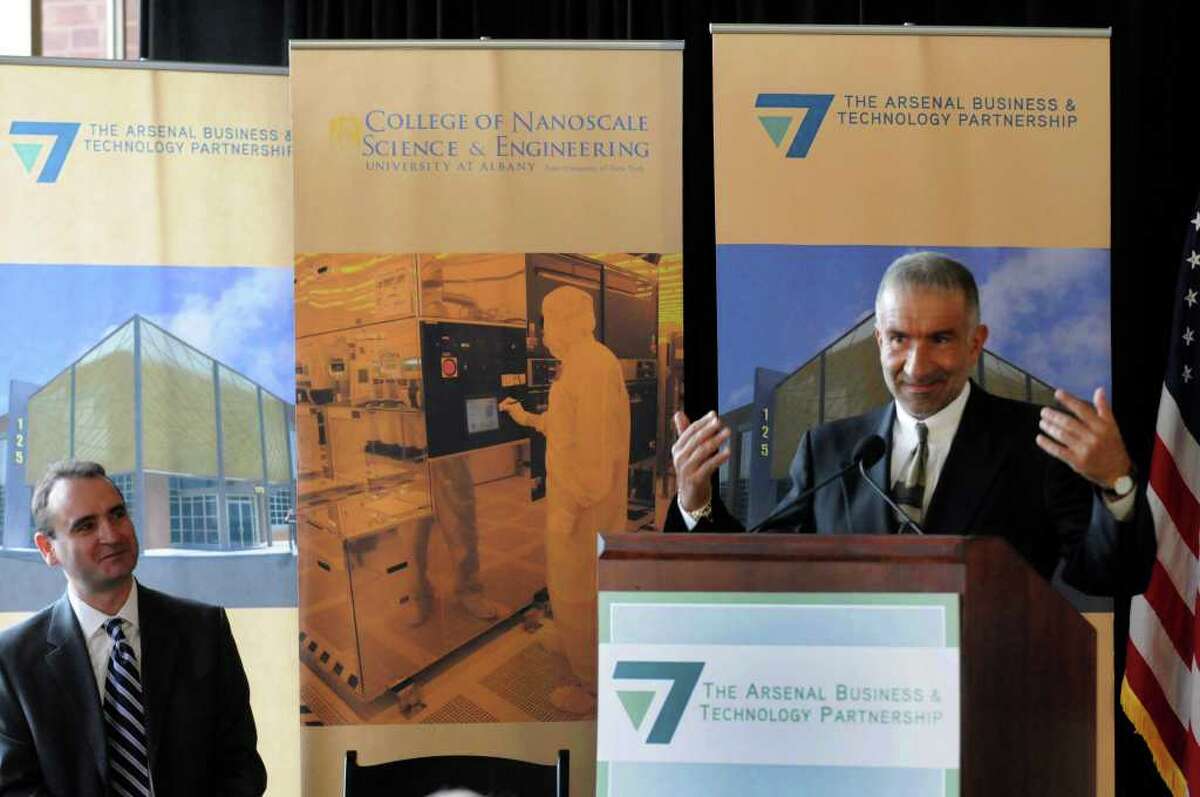 Dr. Alain E. Kaloyeros, senior vice president and CEO of CNSE, right, introduces Panos Angeloppolos, president of Cleveland Polymer Technologies, left, during a press conference to announce Angeloppolos's company moving their headquarters and expanding operations at the Watervliet Arsenal in Watervliet, NY Wednesday, Nov.30, 2011.( Michael P. Farrell/Times Union)