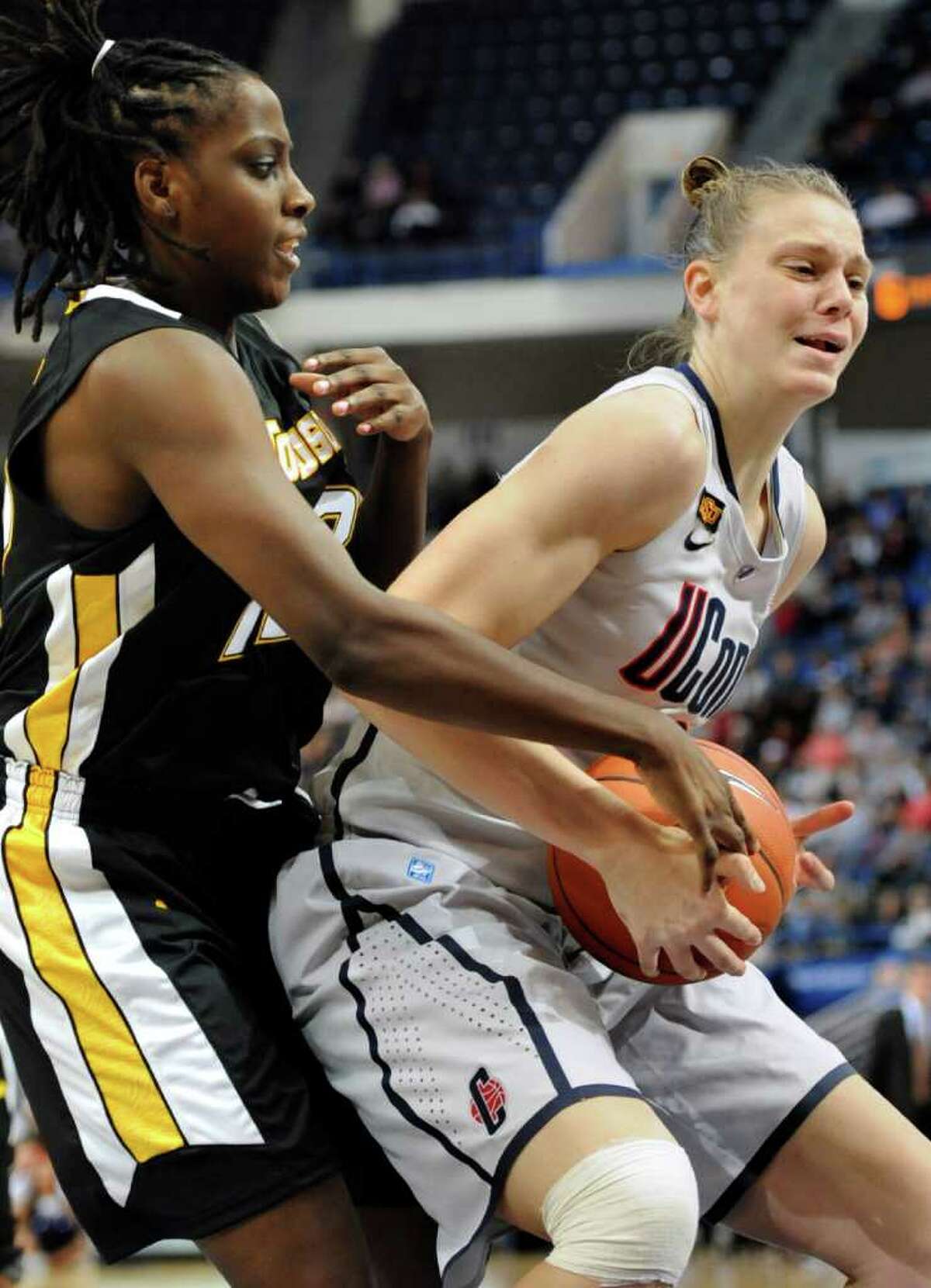 Connecticut's Heather Buck, right, is guarded by Towson's Krystin Fields, left, in the first half of an NCAA college basketball game in Hartford, Conn., Wednesday, Nov. 30, 2011. (AP Photo/Jessica Hill)