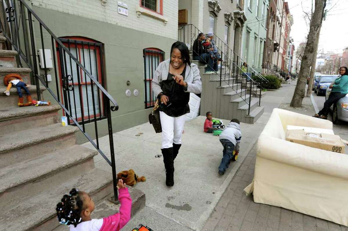 Kym Dorsey greets a neighborhood child on Pearl Street on Monday, April 11, 2011, in Albany, N.Y. (Cindy Schultz / Times Union)