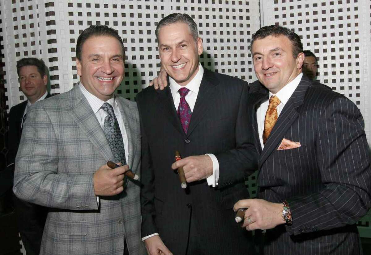Albany, NY - November 25, 2011 - (Photo by Joe Putrock/Special to the Times Union) - (l to r) Mike Reo, Paul Fallati and Rocky Reo enjoy hand rolled cigars in the cigar bar on the patio of the Fort Orange Club during the 13th Annual Holiday Kick Off to benefit St. Peter's Hospital Foundation.