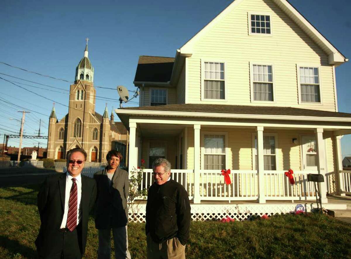 From left; Nicholas Calace, executive director of the Bridgeport Housing Authority, Robbi Dunn-Horris, relocation specialist, and Marvin Farbman, former executive director of Connecticut Legal Services, on the site of the former Father Panik Village housing project on Bridgeport's East Side on Thursday, December 1, 2011.