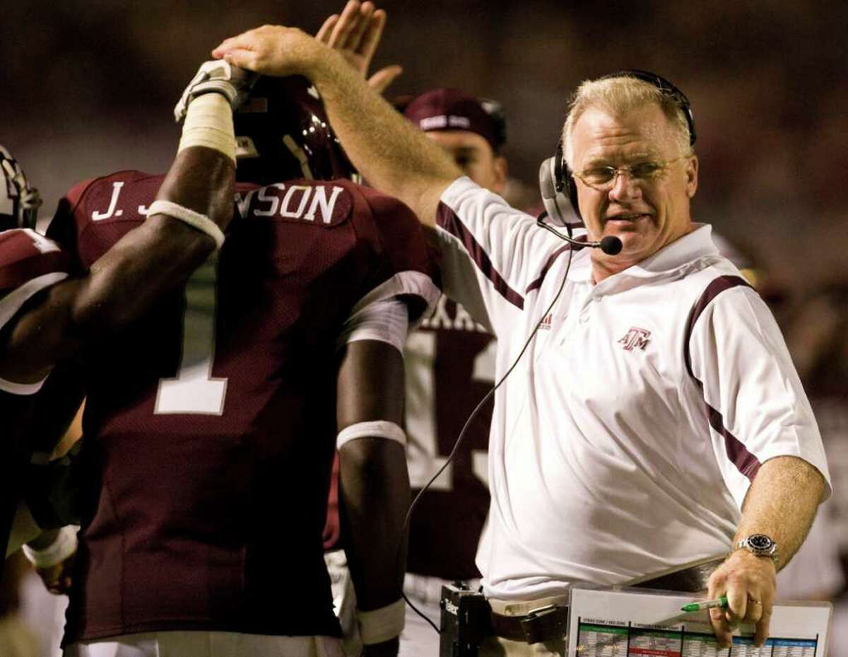 A very happy Texas A&M head coach Mike Sherman congratulates his qaurterback quarterback Jerrod Johnson (1) after a touchdown pass in the fourth quarter of his game Saturday, Sept. 19, 2008, in Kyle Field in College Station. Texas A&M won 38-30. ( Nick de la Torre / Chronicle )