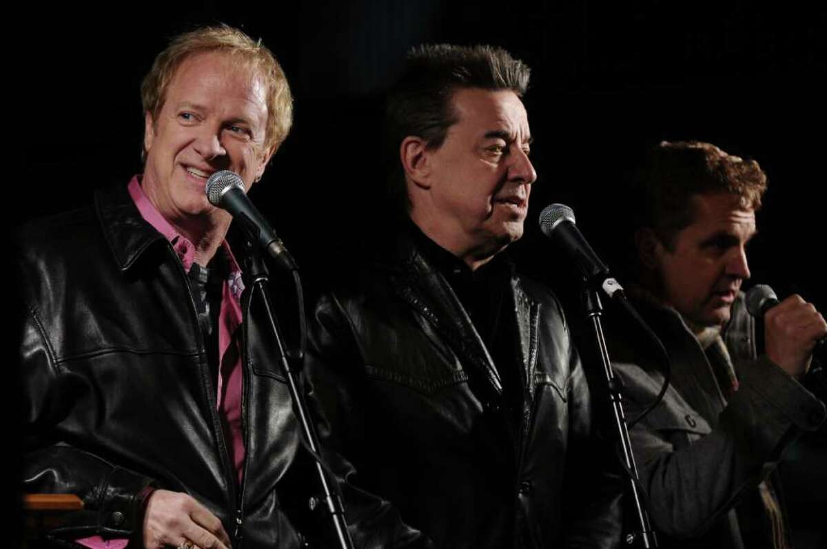 State Street was rededicated as Chicago band members, including Lee Loughnane, left, Walt Parazaider, center, and Jason Scheff, right, sang Christmas songs acapella during a ceremony on Thursday evening Dec. 1, 2011 in Albany, NY. A short fireworks display followed, after the streets holiday lights were turned on .(Philip Kamrass / Times Union )