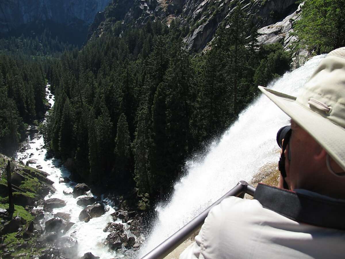 A hiker takes a photo from the top of Vernal Falls in Yosemite in 2011.  On Wednesday afternoon two boys aged 6 and 10 were swept away in the Merced River at the Vernal Fall Footbridge while cooling off during a hike.