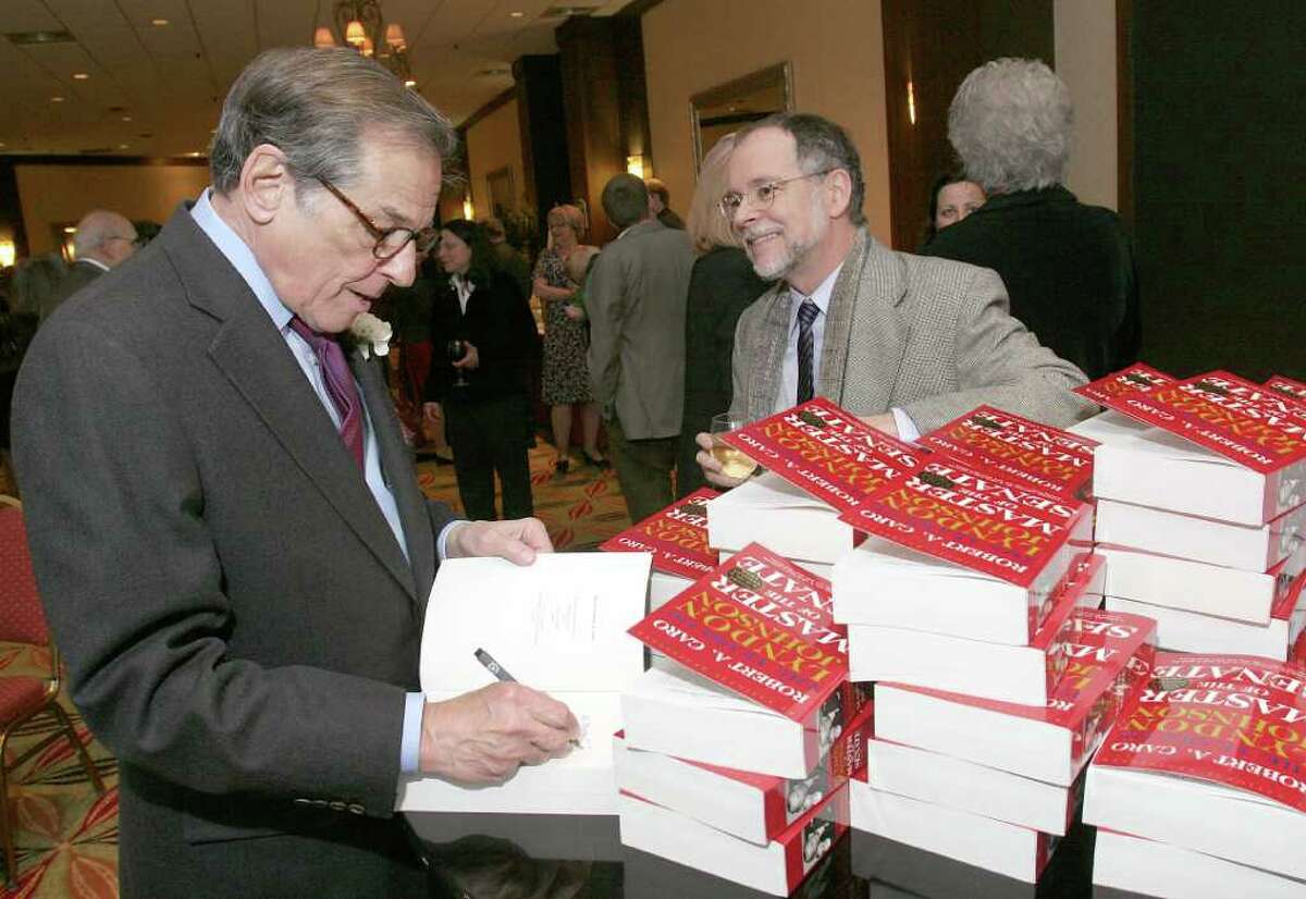 Pulitzer Prize-winning author Robert Caro signs a copy of "Master of the Senate," the third volume of his epic biography of Lyndon Johnson, for fellow author Gregory Maguire ("Wicked") during The Empire State Book Festival Gala and Writers Hall of Fame Induction Ceremony in April 2010.