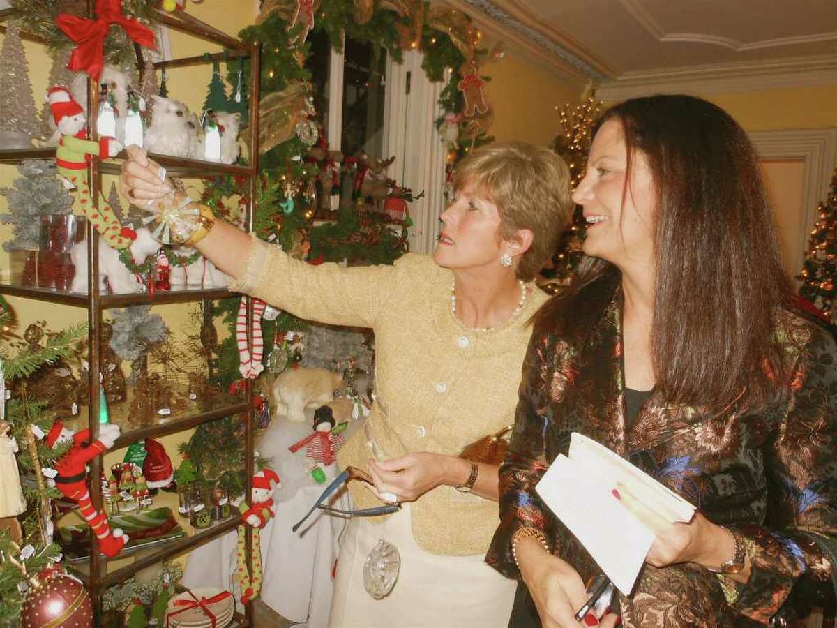 Connie Tunley of Greenwich and Patty Hesse, of Fairfield look at glass sea-themed ornaments at the Fairfield Christmas Tree Festival in the Burr Homestead.