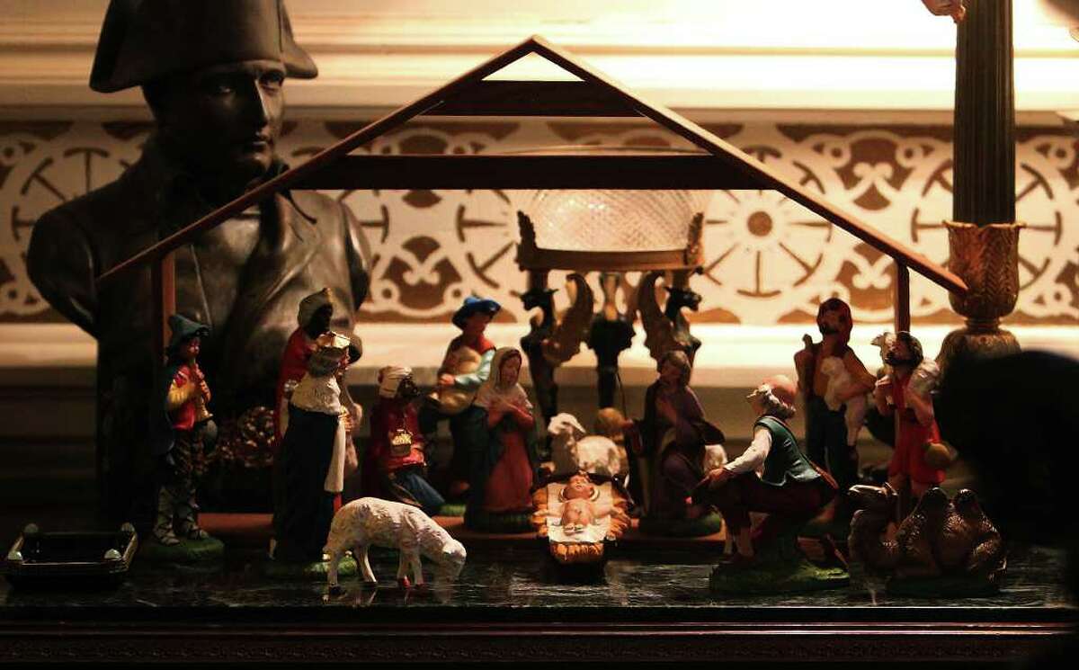 A Nativity scene made of Italian plaster is among items on a Napoleanic-themed desktop. Walter Mathis was a huge collector of vintage holiday decorations.