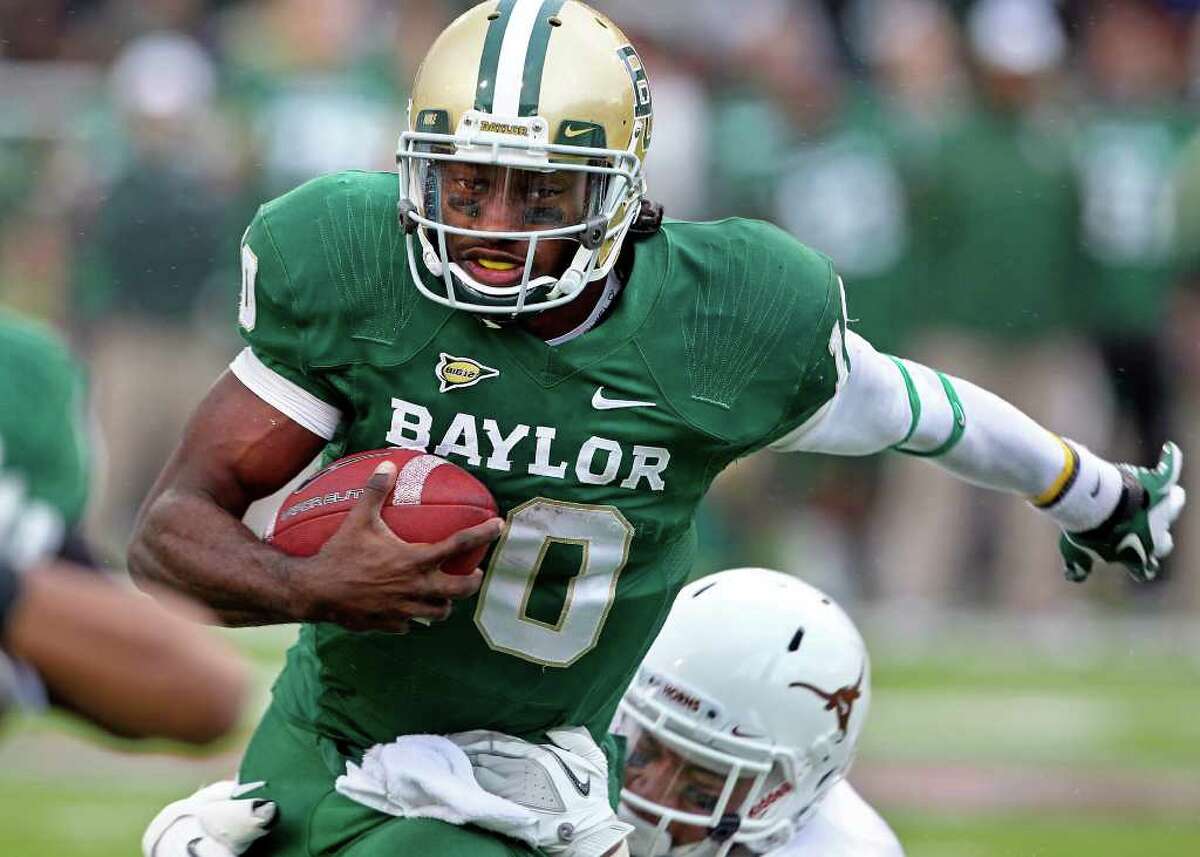 Bears quarterback Robert Griffin III carries the ball near the goal line in the second quarter as Baylor hosts Texas at Floyd Casey Stadium in Waco on Saturday, Dec. 3, 2011.