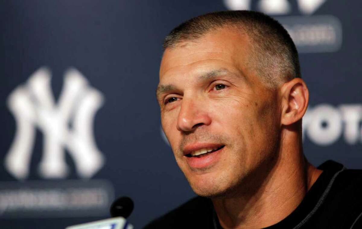 Joe Girardi is joined by wife Kim for a news conference at Yankee