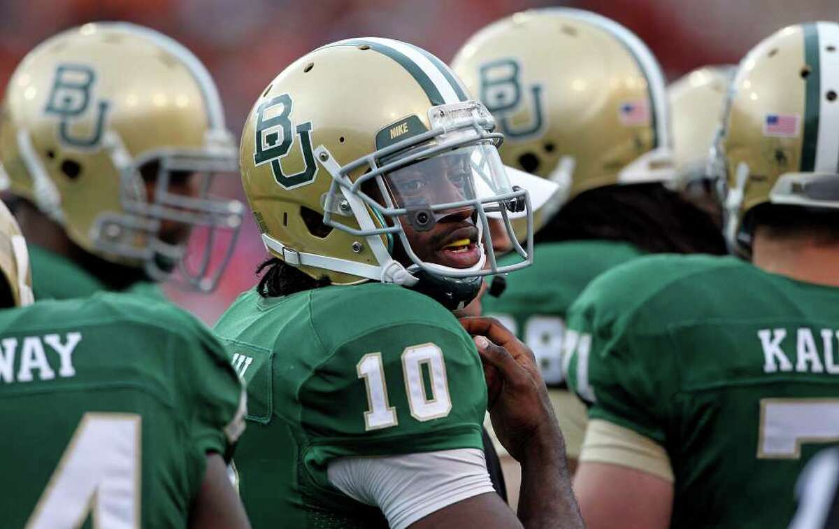 Bears quarterback Robert Griffin III looks to the sideline for instructions as Baylor hosts Texas at Floyd Casey Stadium in Waco on Saturday, Dec. 3, 2011.