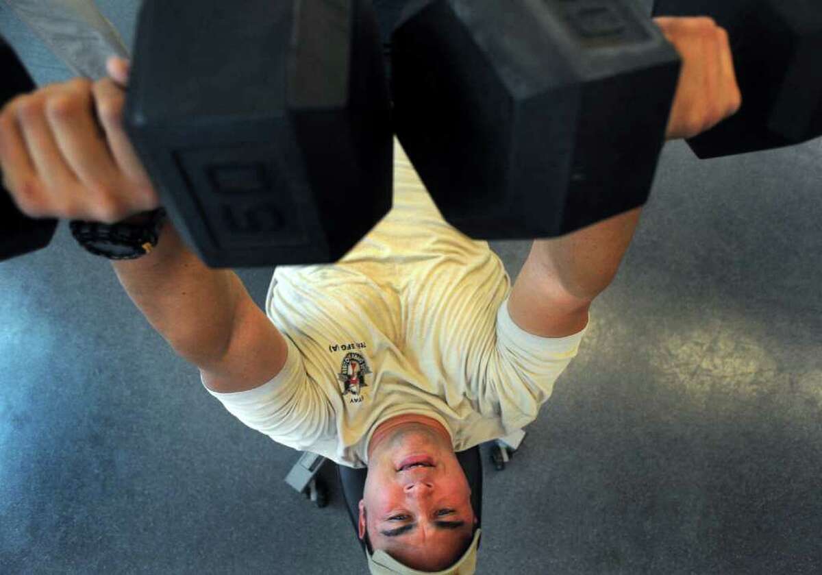 Army Capt. William Lyles, who was wounded by a land mine in Afghanistan in 2010, works with weights at the Center for the Intrepid at Brooke Army Medical Center on Tuesday, Nov. 15, 2011. BILLY CALZADA / gcalzada@express-news.net Story by Sig