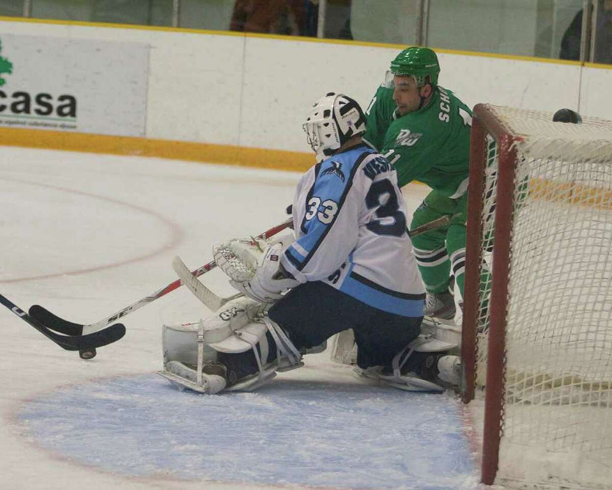The Whalers' Lucas Schott, right, tries to get his stick on a rebound in front of Cape Cod goal Wes Vesprini Sunday night at the Danbury Arena.