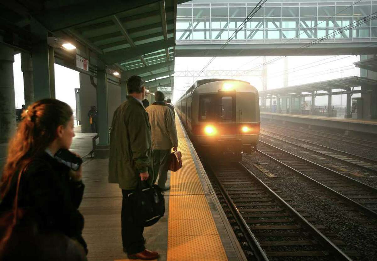 Commuters prepare to board the train during the opening morning of the Fairfield Metro Station on Monday, December 5, 2011.