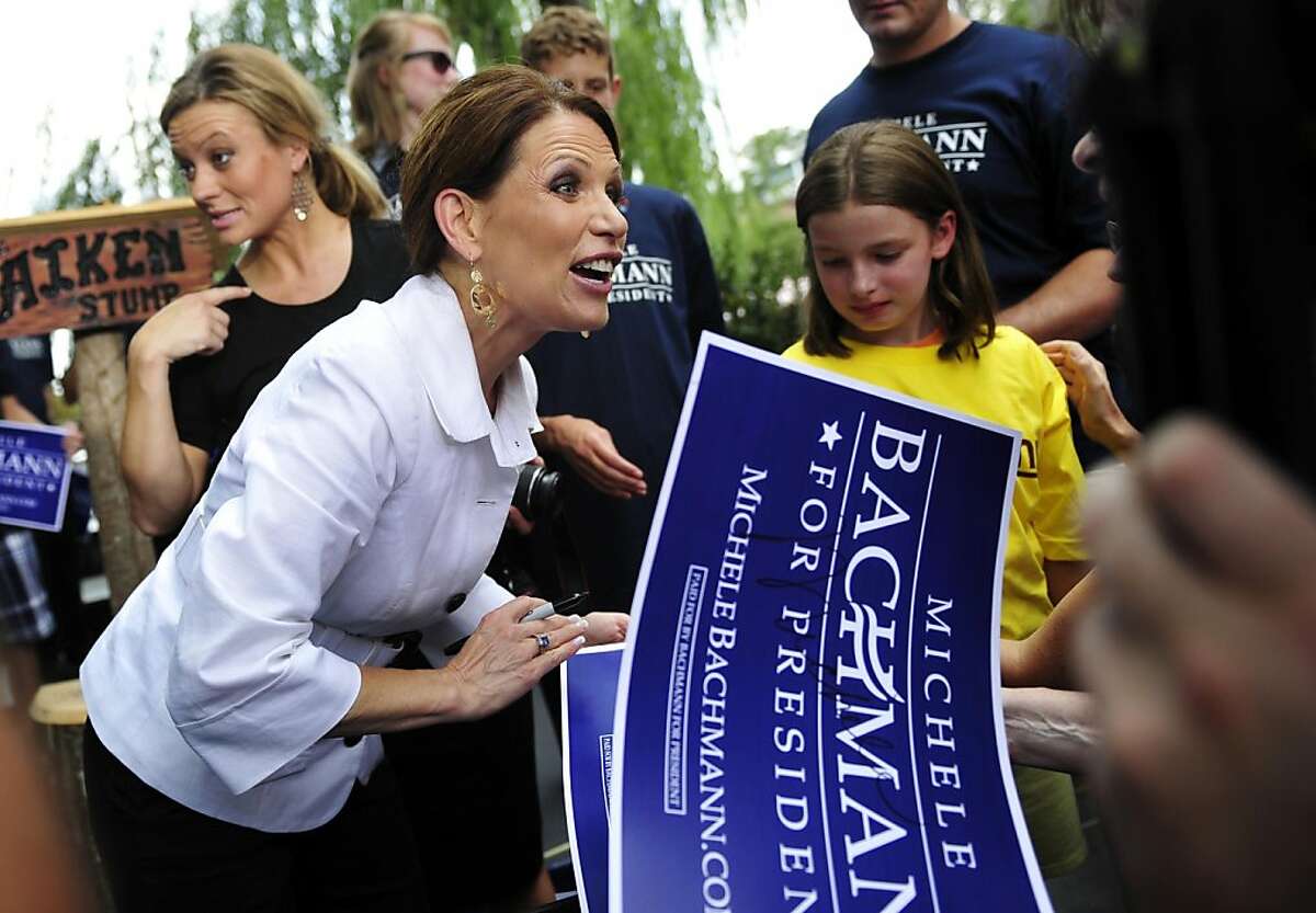 Republican presidential candidate, Rep. Michele Bachmann, R-Minn., speaks with supporters after a political rally, Tuesday, July 19, 2011, in downtown Aiken, S.C. (AP Photo/The Augusta Chronicle, Rainier Ehrhardt) MAGS OUT, TV OUT, NO SALES, MANDATORY CREDIT