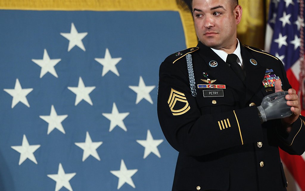 Army Sgt. 1st Class Leroy Arthur Petry applauds during a ceremony at the  White House in