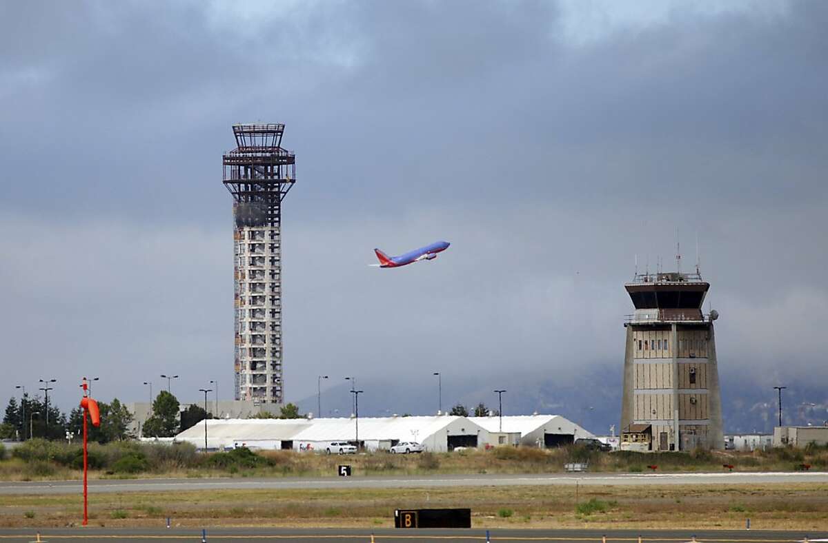 A Southwest Airlines jet takes off near a partially built control tower, left, at Oakland International Airport in Oakland on Tuesday..