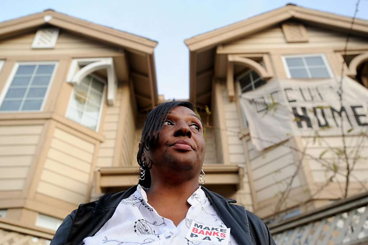 Standing outside her foreclosed Adeline St. home, Gayla Newsome joins about a hundred Occupy Oakland protesters rallying against home foreclosures on Tuesday, Dec. 6, 2011, in Oakland, Calif. Newsome said supporters reoccupied her home earlier in the day, four months after sheriff's evicted her family in July.