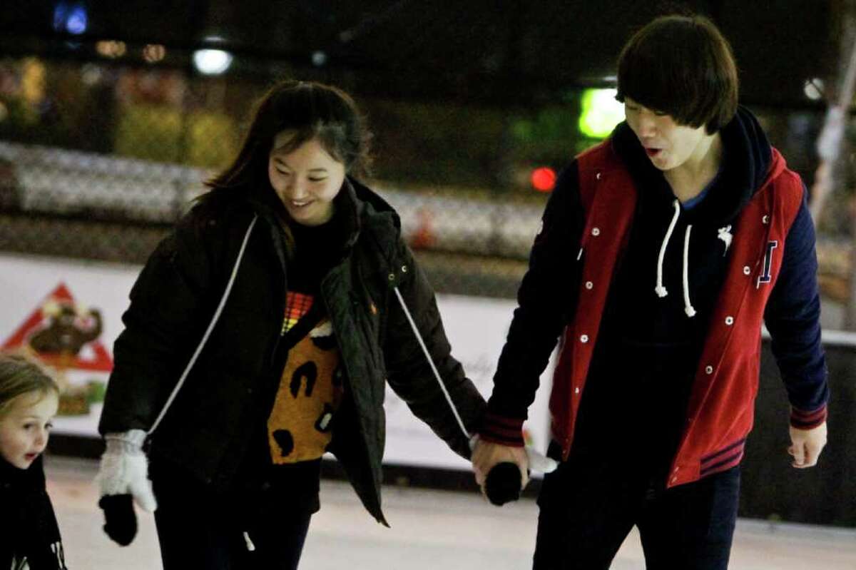 Doyeon Ki, and Kevin Baek skate at the Capitol Hill Ice Rink located at Cal Anderson Park in Seattle on Dec. 6, 2011.