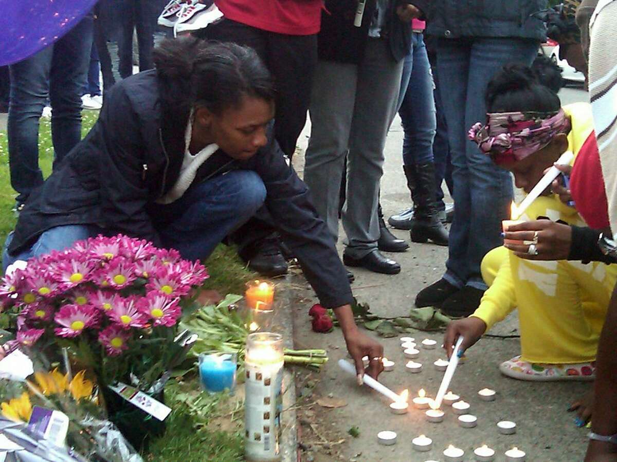 07/16/2011 - http://seattletimes.nwsource.com/ABPub/2011/07/14/2015615970.jpg Rose Bankston, left, lights a candle during a vigil Thursday for her niece Tanaya Gilbert, 19, who was shot and killed the night before in South Seattle.Rose Bankston,left, aunt of Tanaya Gilbert, lights a candle during a vigil Thursday, July 14, 2011 for Gilbert, 19, who was shot and killed the night before in South Seattle.