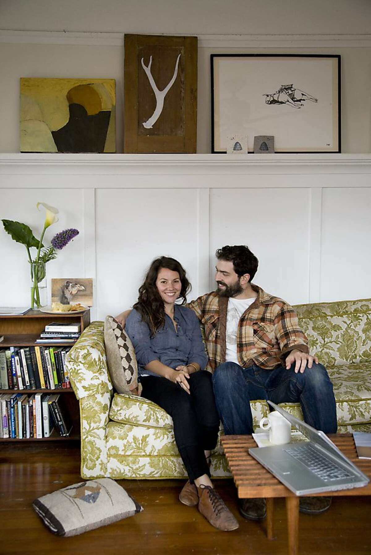 Artist and ceramicist Jessica Niello and chef Sam White sit in the living room of their homespun West Oakland retreat.