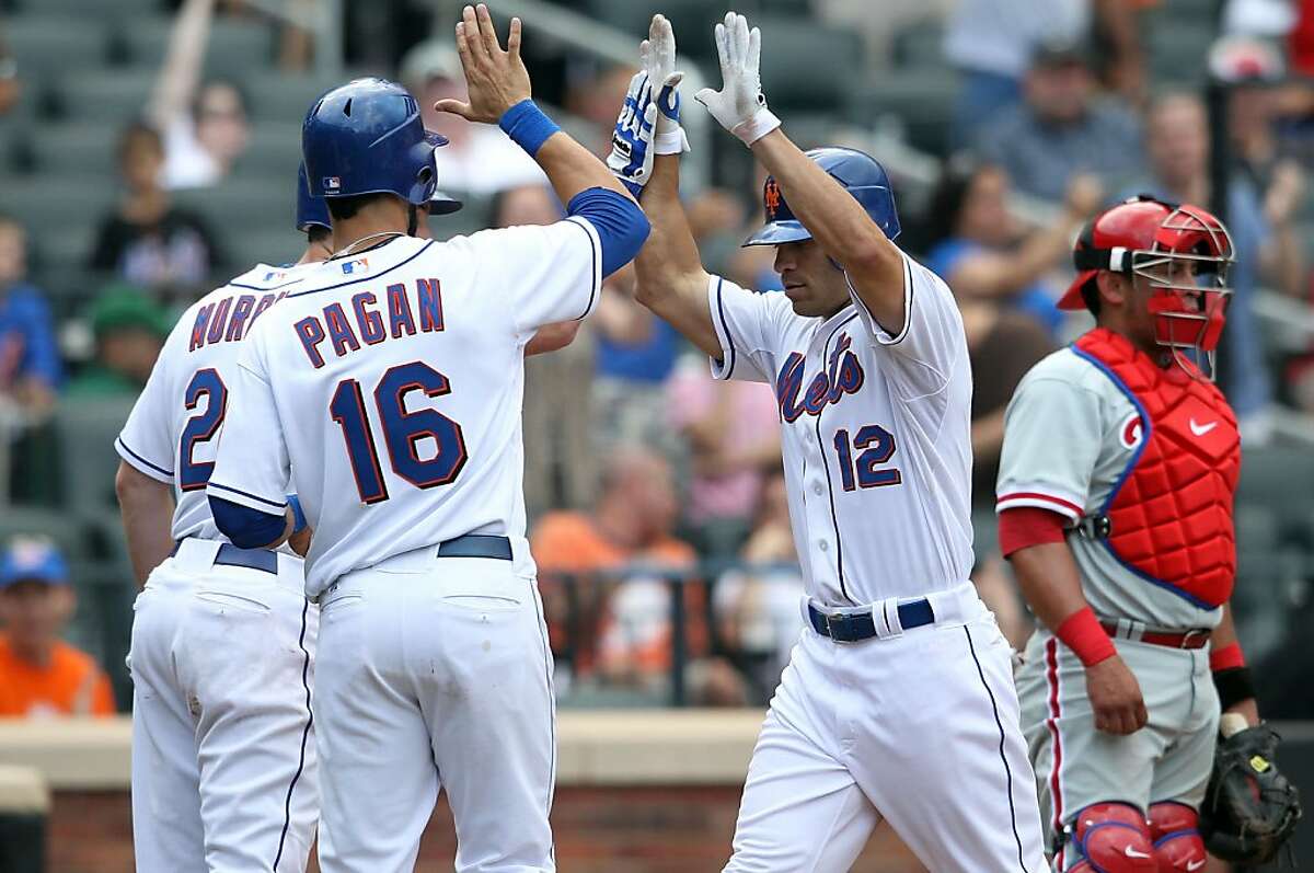 NEW YORK, NY - JULY 16: Scott Hairston #12 of the New York Mets celebrates his 3 RBI home run with Daniel Murphy #28 and Angel Pagan #16 against the Philadelphia Phillies at Citi Field on July 16, 2011 in the Flushing neighborhood of the Queens borough of New York City.