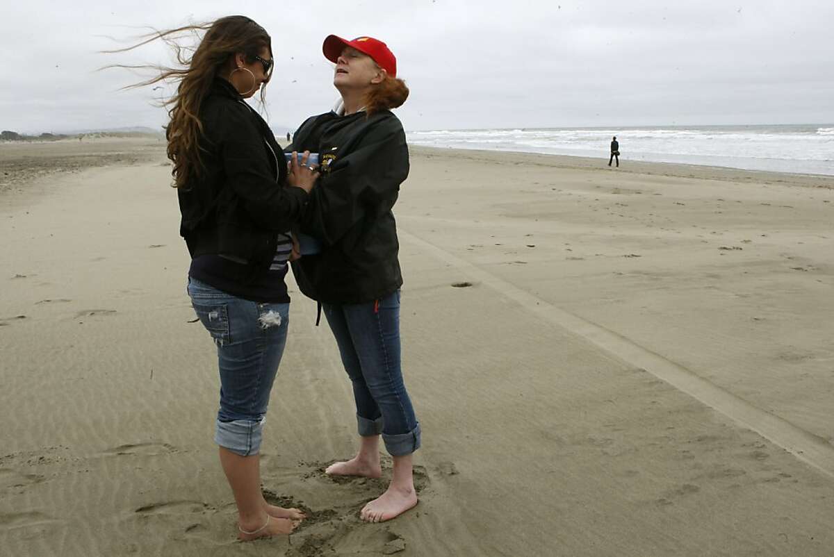 Mother Claudia Stevens (right) is joined by Erica Menezes (left), college friend of Danielle Keller, as Claudia hugs the urn of her daughter's ashes before bringing some to the waterline at Ocean Beach in San Francisco, Calif. on Monday, July11, 2011. She is honoring the anniversary and memory of her daughter, Danielle Keller,who was murdered with a baseball bat two years ago. Erica and Danielle were best friends before her death and had flown in from southern California for the anniversary and verdict.