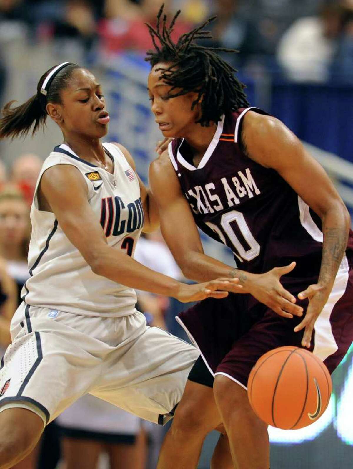 Connecticut's Tiffany Hayes, left, pressures Texas A&M's Tyra White, right in the first half of an NCAA college basketball game in Hartford, Conn., Tuesday, Dec. 6, 2011. (AP Photo/Jessica Hill)