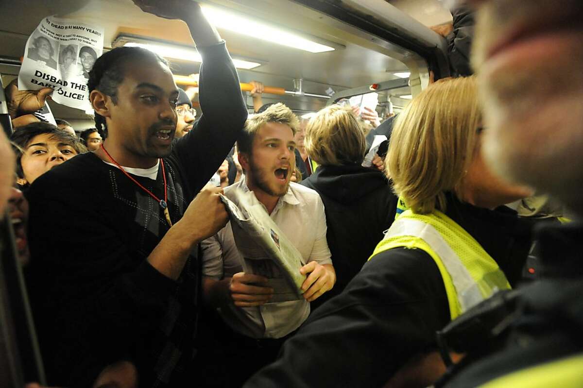 Some protesters cram into a train at the Civic Center Platform while BART employees tried to keep them off the train on July 11, 2011. The protest was held where Charles Hill was killed by BART police on July 2, 2011.