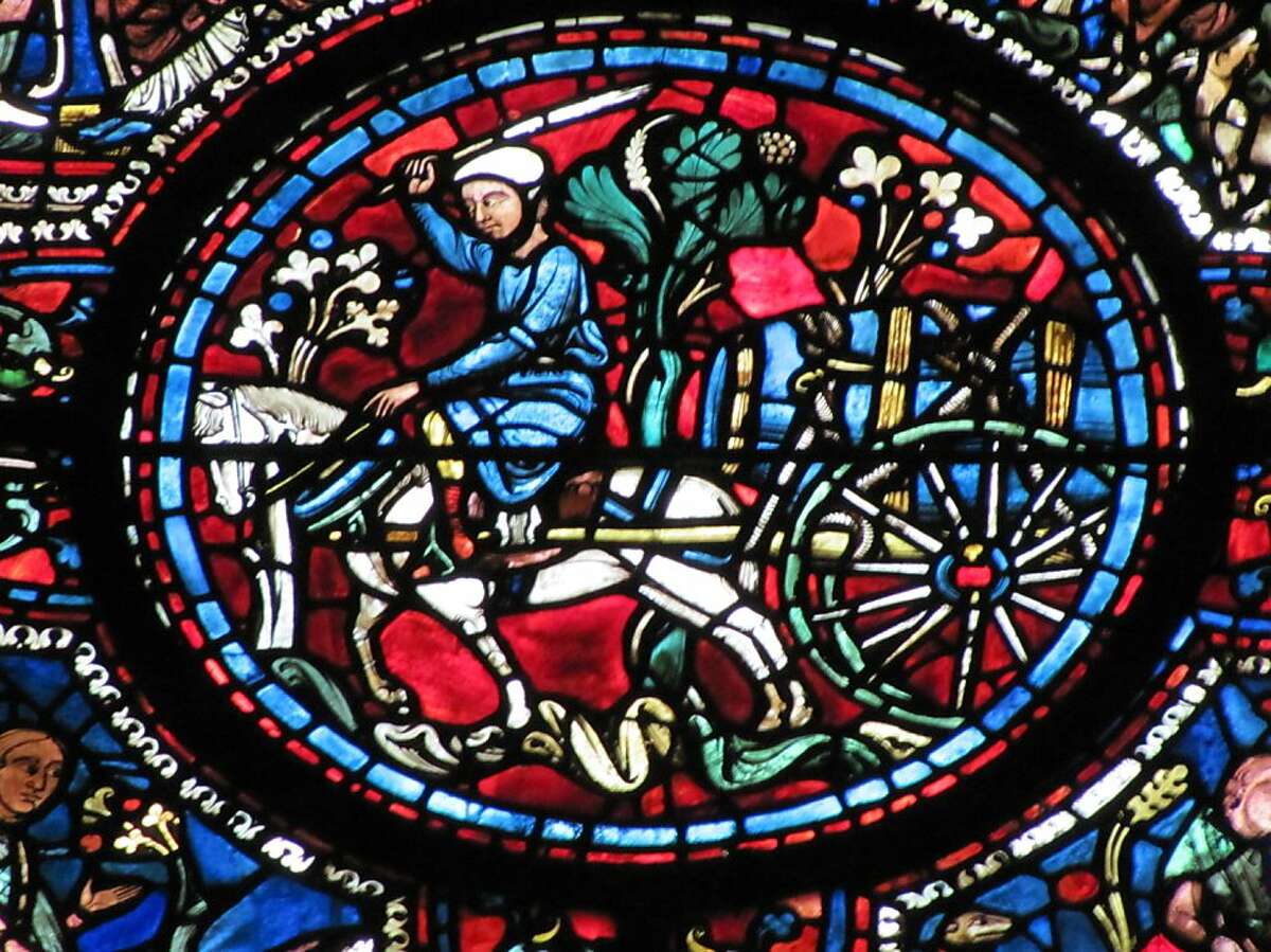 Close up of one section of an early 13th-century stained glass window in Chartres Cathedral, showing a horse-drawn wagon and barrel belonging to the guild of water-carriers. The guild payed for the window.