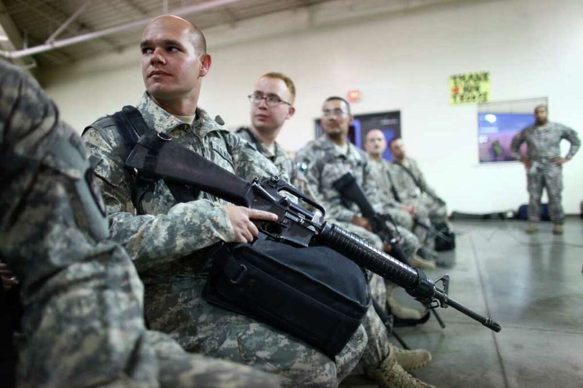 SSgt. Kelly Sawlsville of the 62nd Medical Brigade waits to turn in his weapon at Joint Base Lewis-McChord.
