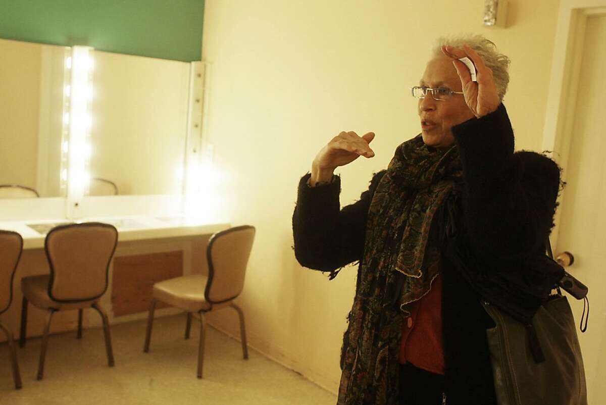Judy Nemzoff, Community Arts and Education program director, is seen in the girls Dressing Room at the Bayview Opera House where moisture leaking through the south wall is seen in the background (lower left) on Tuesday, June 28, 2011 in San Francisco, Calif.