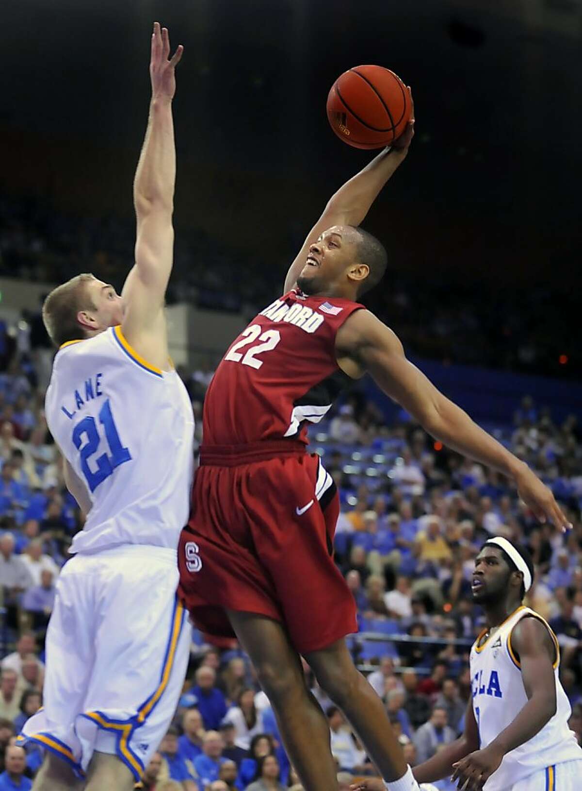 Stanford's Jarrett Mann, right, goes to the basket as UCLA's Brendan Lane defends in the first half of an NCAA college basketball game, Saturday, Jan. 22, 2011, in Los Angeles.