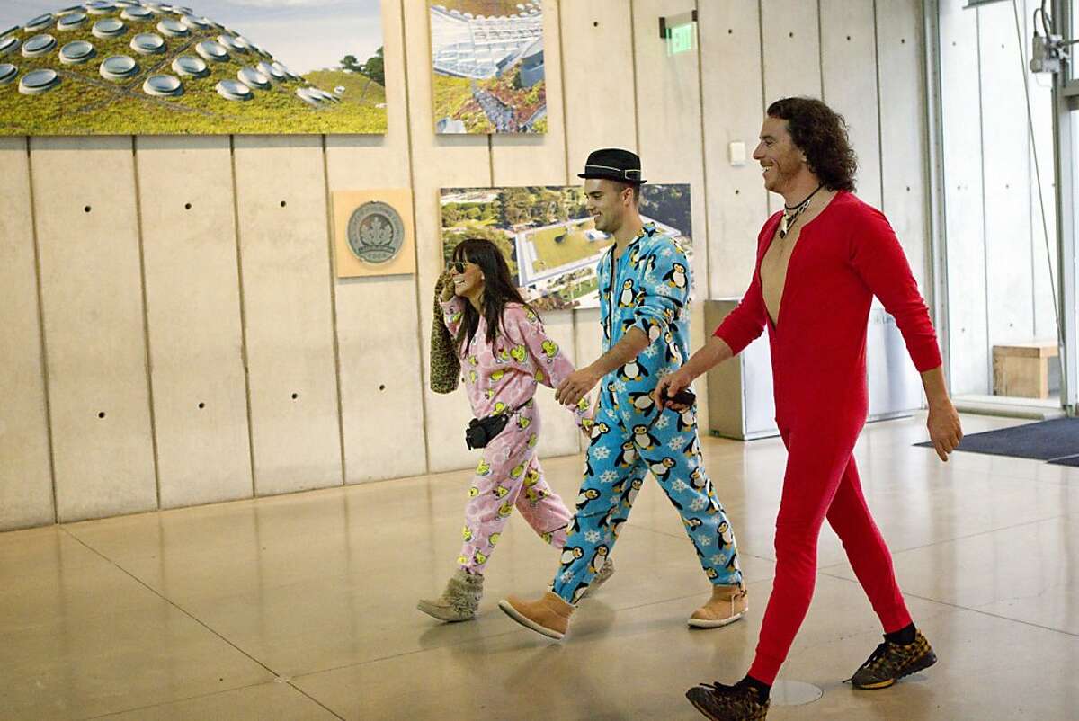 Martha Chavarro, Guillermo Sanchez de Corral and Alvaro Bravo (left to right) walk through the California Academy of Sciences in pajamas while attending the first ever adults only version of the museum's popular Penguins and Pajamas event in San Francisco, Calif., on Saturday, June 4, 2011.
