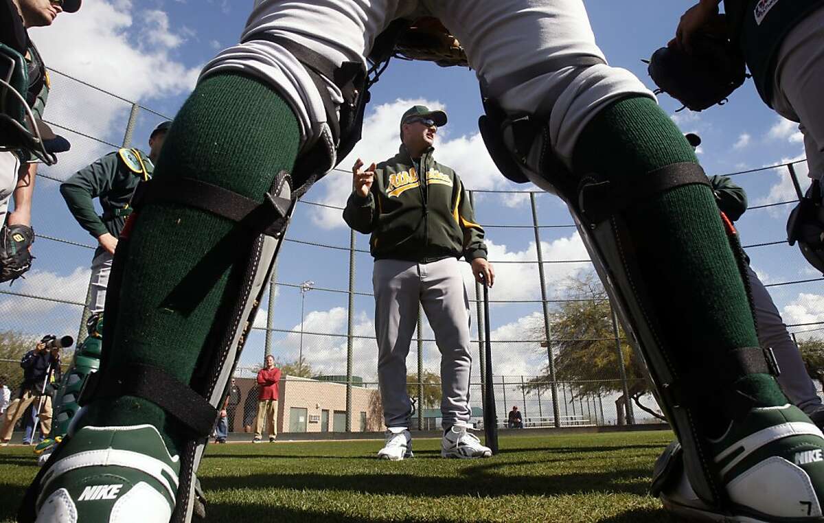 Oakland Athletics Manager Bob Geren talks with the catchers during Spring Training workouts at the Papago Baseball Complex Tuesday February 17, 2009 in Phoenix Arizona.