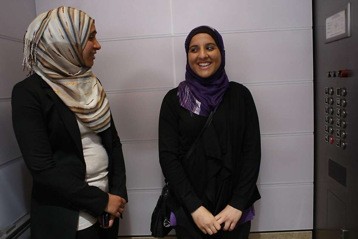 Zahra Billoo (left), executive director of the SF Bay Area office of the Council on American-Islamic Relations, with plaintiff Hani Khan (right) from San Mateo talk after a press conference in San Francisco, Calif., on Monday, June 27, 2011. Hani was fired at a Hollister Co. store in the Hillsdale Mall location for refusing to remove her religious head scarf, or hijab. She is filing a lawsuit today in the U.S. District Court for the Northern District of California against Abercrombie & Fitch.
