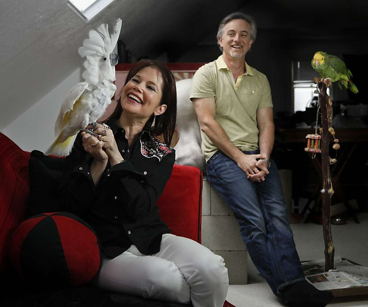 Film producers Dayna Goldfine and Dan Geller are seen with their cockatoo, Daphne, and parrot, Seymour, in their San Francisco, Calif., home on Monday, May 16, 2011.