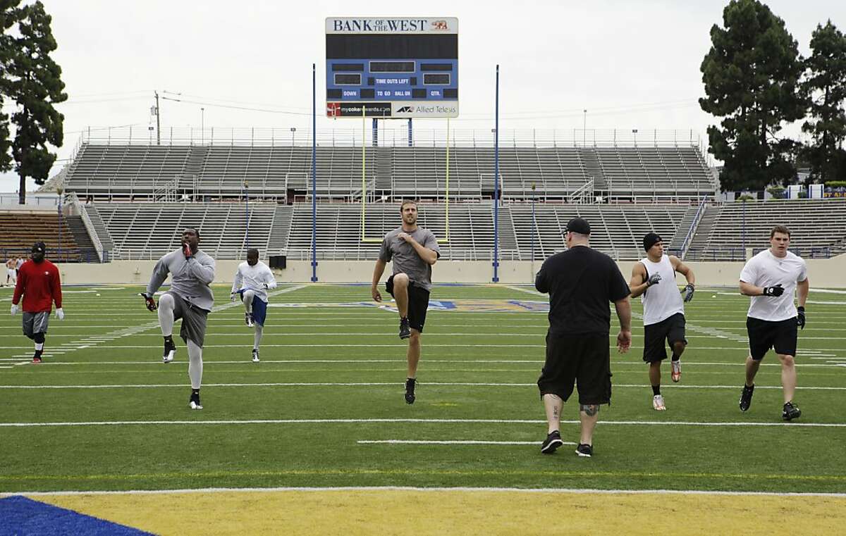 San Francisco 49ers quarterback Alex Smith, center, who is a free agent, leads an informal mini-camp during the NFL football lockout at San Jose State University in San Jose, Calif., Tuesday, June 28, 2011.