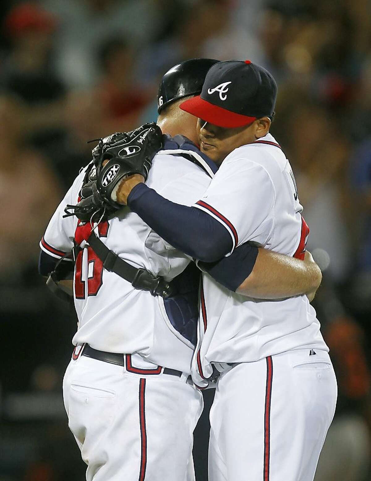 Atlanta Braves starting pitcher Jair Jurrjens, right, embraces catcher Brian McCann after shutting out Baltimore Orioles of an interleague baseball game in Atlanta, Friday, July 1, 2011. Jurrjens earned his 11th win of the season with a one-hit shutout. Atlanta won 4-0.