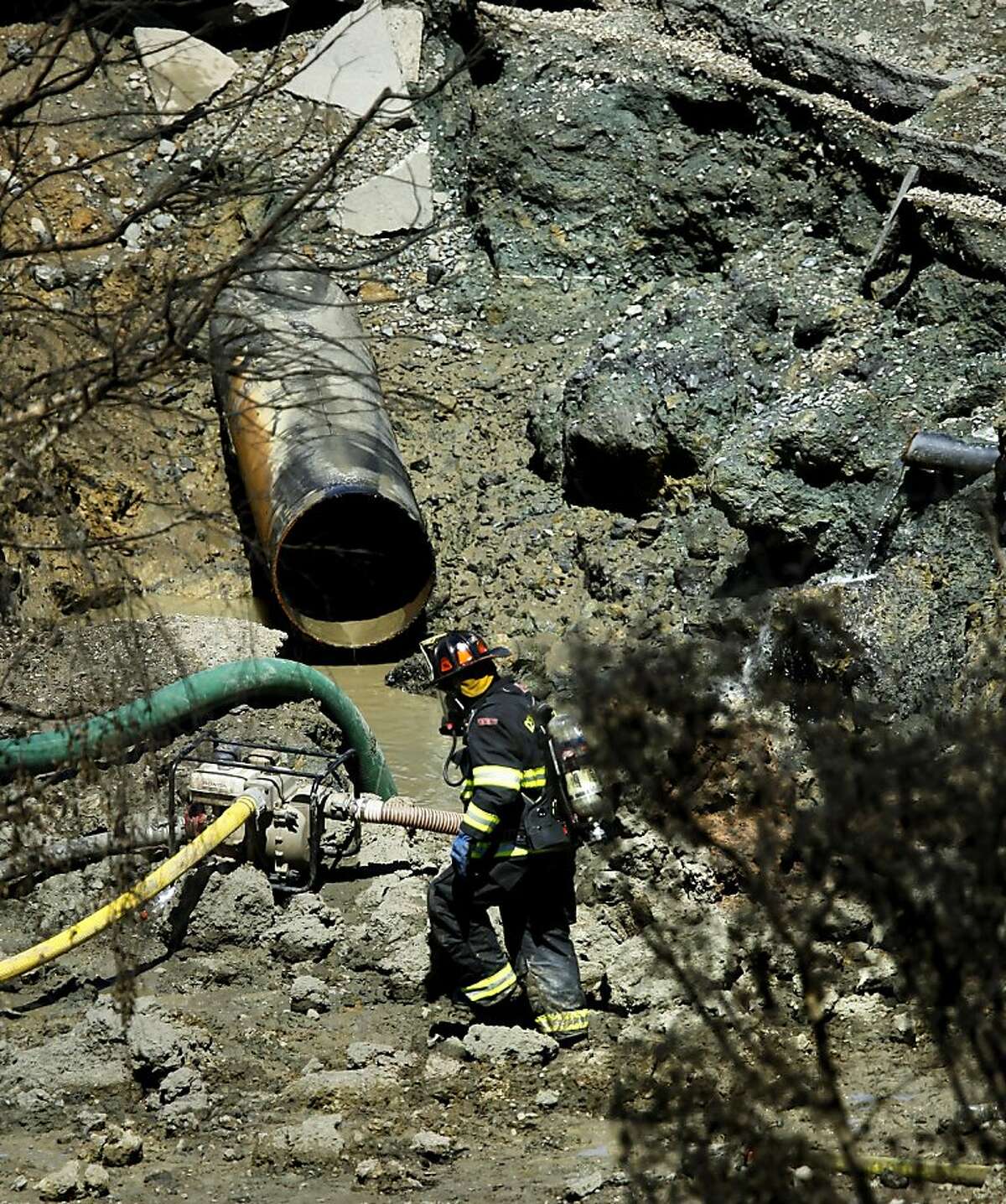 A firefighter at the blast site where the hugh natural gas line in now exposed inside a large crater on Friday Sept. 10, 2010, in which an explosion and fire leveled the surrounding neighborhood the night before in San Bruno, Calif. Ran on: 09-11-2010 A firefighter at the San Bruno blast site views the natural-gas pipeline now exposed inside the crater the explosion caused. Ran on: 09-24-2010 A firefighter works at the site of the San Bruno gas line blast. Investigators are looking at microbes as a possible cause. Ran on: 01-14-2011 The blast site in San Bruno where the huge natural gas pipeline exploded in September. Ran on: 06-29-2011 A severed gas line sits at the site of the blast. An expert says records suggest fluctuating pressure could have weakened it. Ran on: 06-29-2011 A severed gas line sits at the site of the blast. An expert says records suggest fluctuating pressure could have weakened it.