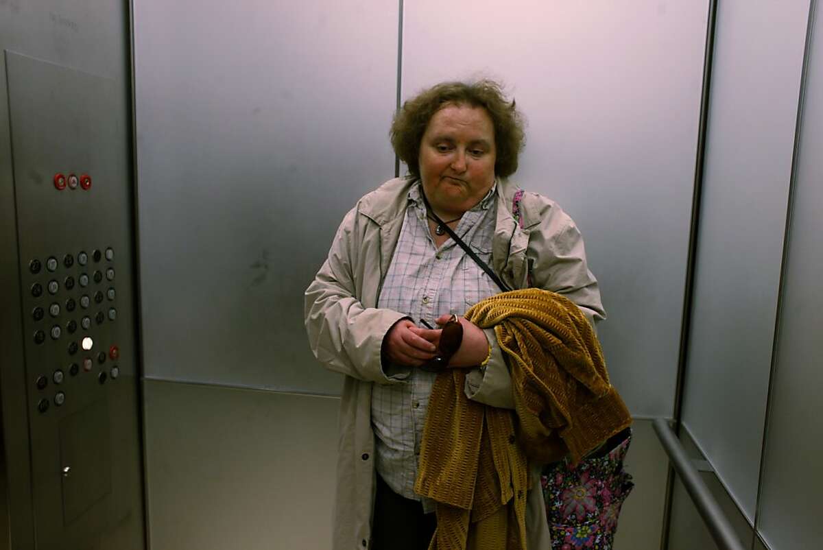 Yvonne Paige, an office assistant at a tech company called Marin Software, rides the elevator down to the first floor after work on Wednesday June 28, 2011 in San Francisco, Calif. Despite a developmental disability Paige thrives at the company. "We'd be a disaster without her. She's one of our hardest workers," said Melissa Albers who's been her boss for the past 9 months. Paige had help finding the her full benefits position with the help of her job coach at The Arc - a program that exists largely with the help of state funds that are slated to be cut dramatically soon.