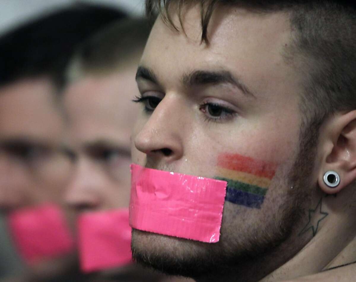Gay marriage supporter Daniel Bracciale of New York wears tape over his mouth during a rally in a hallway outside a Senate Republican conference room at the Capitol in Albany, N.Y., on Thursday, June 23, 2011. Dozens of gay couples are planning to converge on Albany Thursday to witness what would be a historic vote to legalize gay marriage in New York. Supporter wear the tape to signify that they are at the Capitol to talk to senators, and not opponents, about marriage equality.