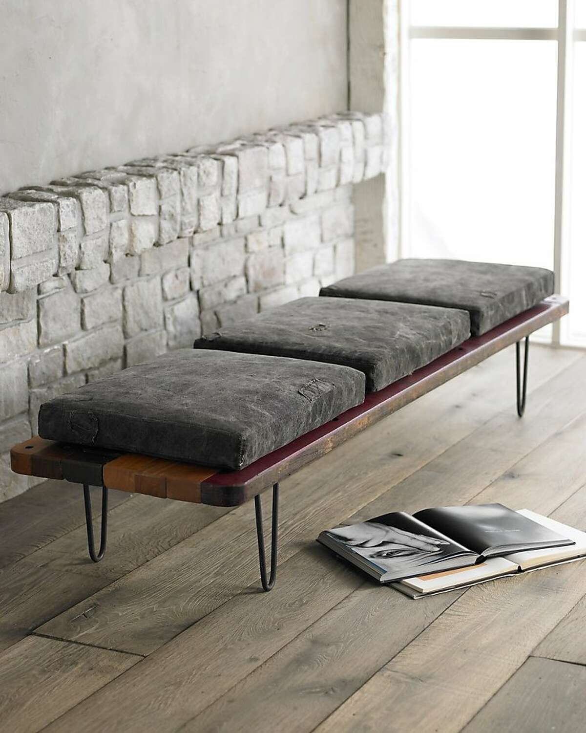 Bench is handcrafted of reclaimed South American hardwoods with natural wax and black finish. Cushions are covered with canvas and may be embellished with letters and patches with different colored stitching.