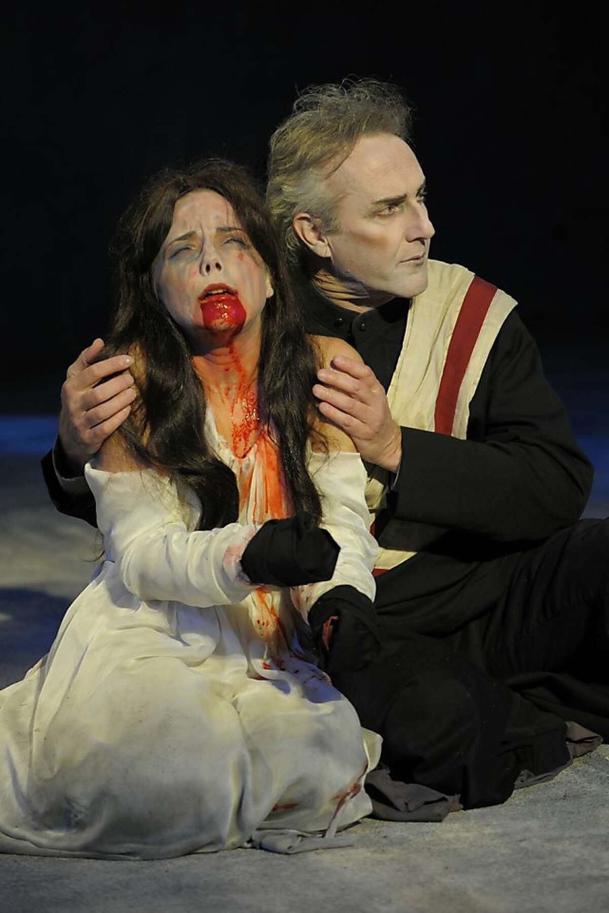 Lavinia (Anna Bullard) is comforted by her uncle Marcus (Dan Hiatt) after she's been raped, had her hands lopped off and tongue ripped out in Shakespeare's "Titus Andronicus" at California Shakespeare Theater