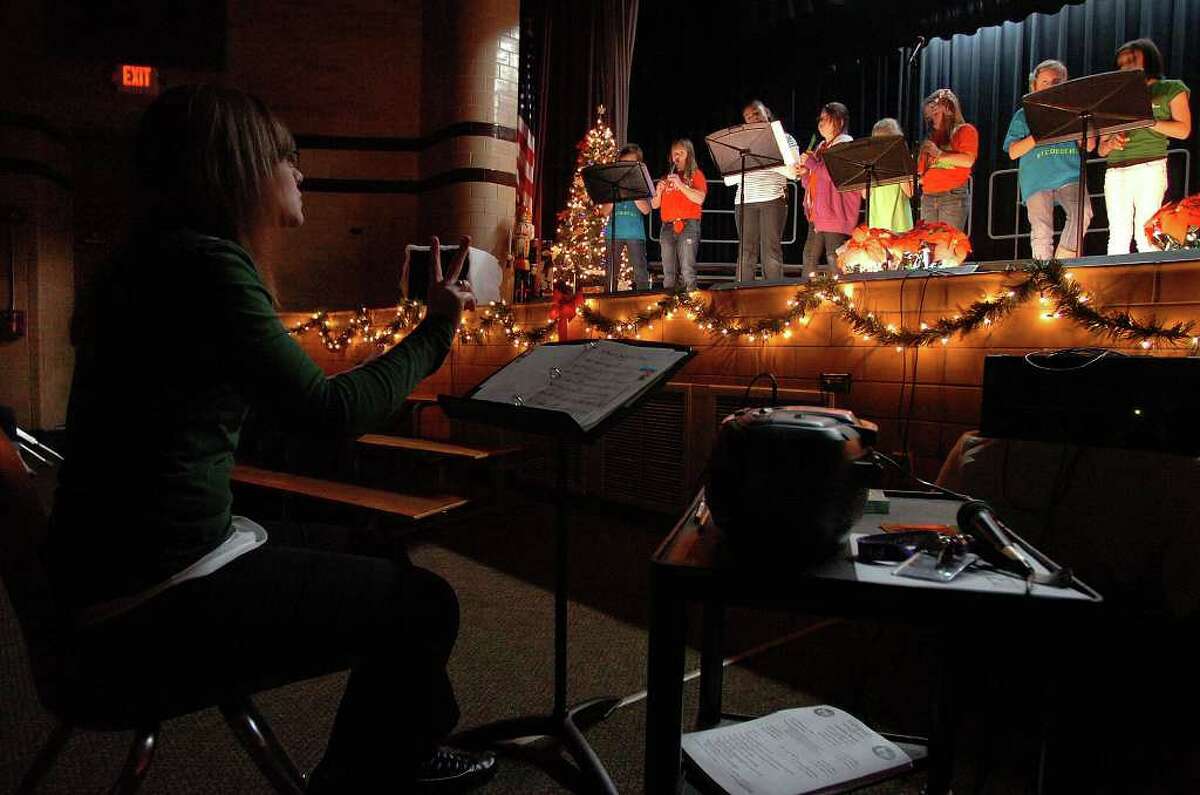 Groves Elementary's Alisa Bell conducts a Christmas program at the school on Monday. Some Southeast Texas schools are removing similar programs from holiday activities. Photo taken Tuesday, December 6, 2011 Guiseppe Barranco/The Enterprise