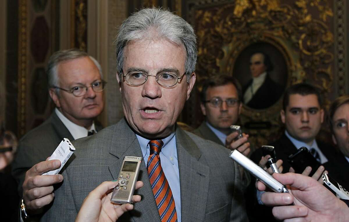 Sen. Tom Coburn, R-Okla., talks with reporters before their caucus luncheon on Capitol Hill Tuesday, June 14, 2011 in Washington.