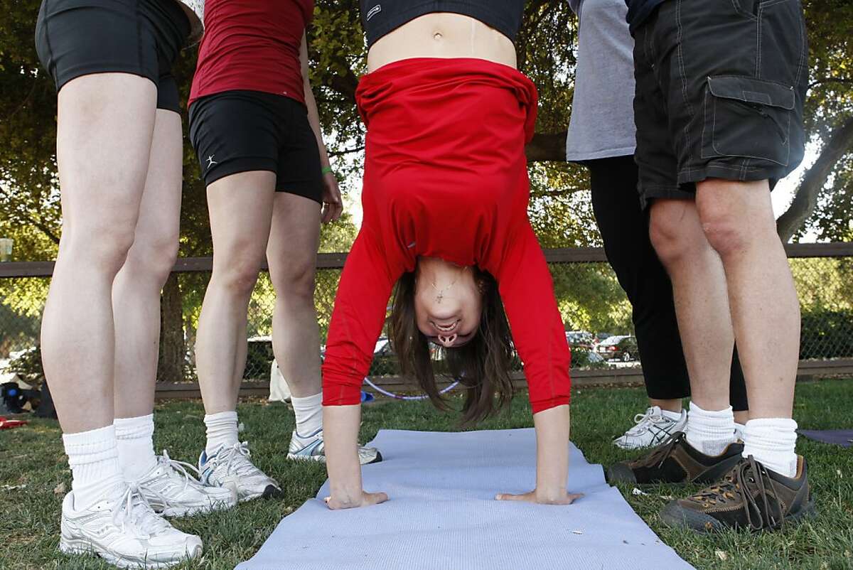 Tiffany VanAlft a liver recipient does a hand stand during the transplant bootcamp held at Stanford University in Stanford Calif, on Wednesday, May 4, 2011.
